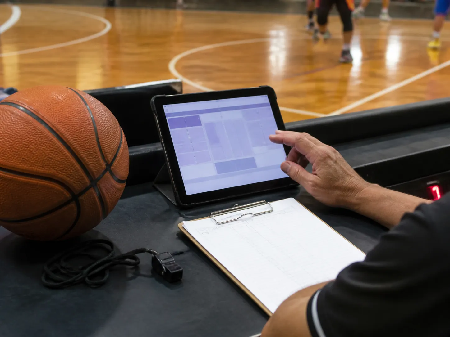 Competition documents and a tablet ready for a basketball rules check